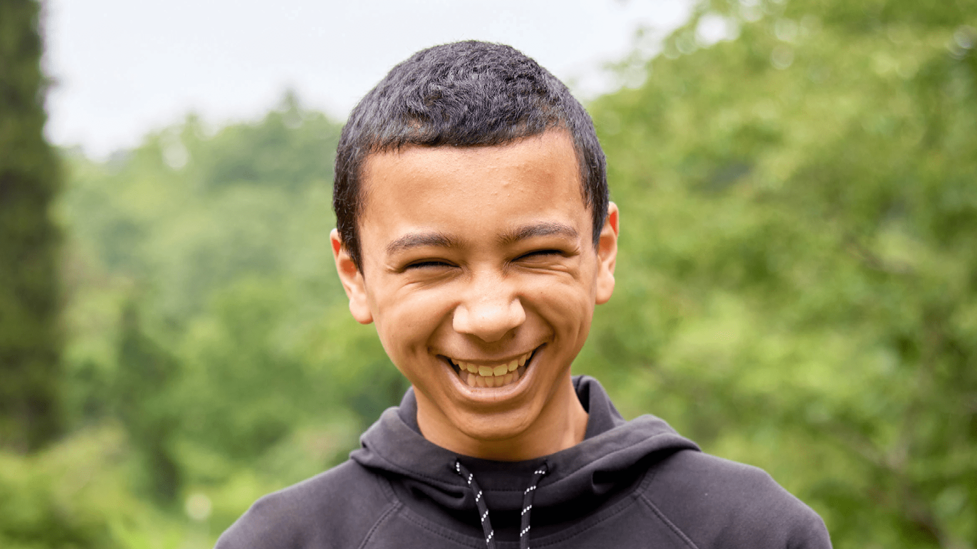 Boy smiles.