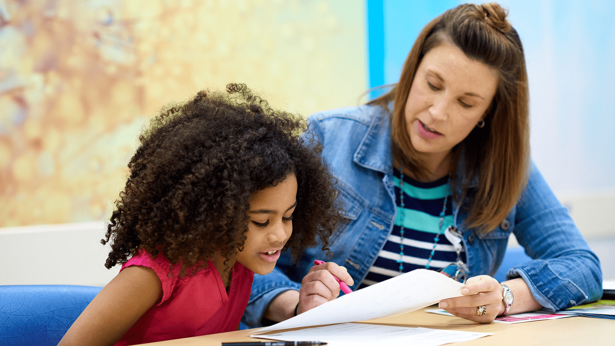 An employee reads to a child.