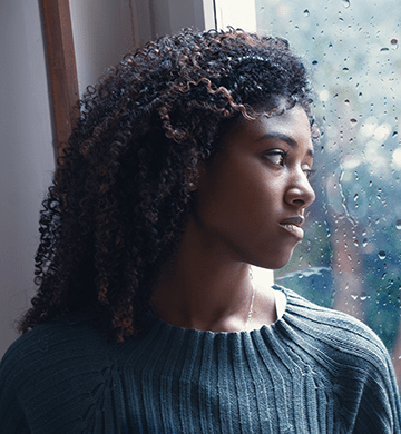 A young girl looks out the window.