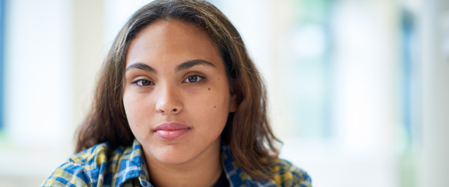 A photo of an adolescent girl smiling.