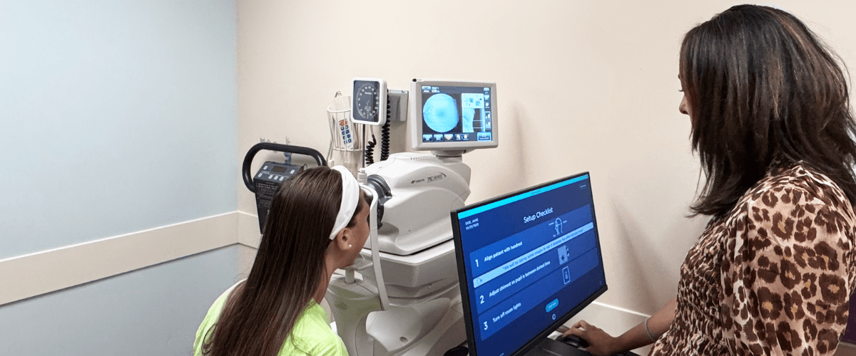 A provider and child looking at a screen together.