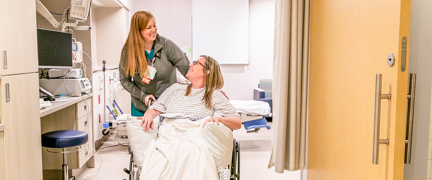 A nurse assists a patient.