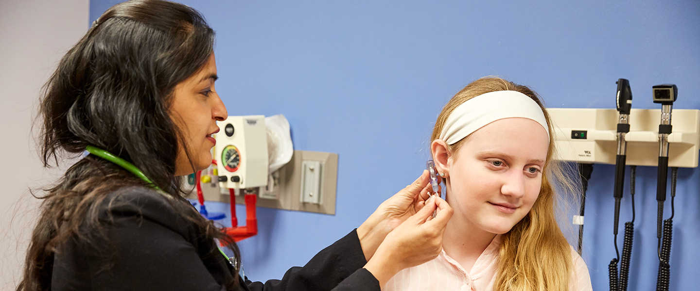 A photo of a doctor examining a patient.