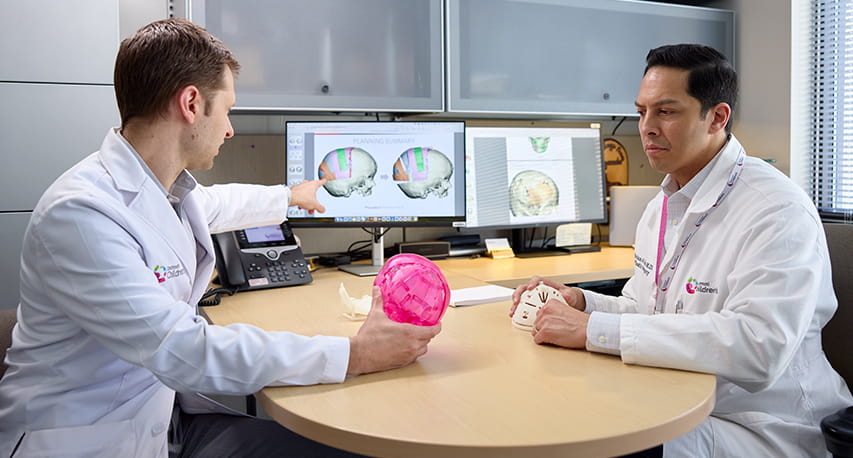 Surgeons meet for virtual surgical planning.