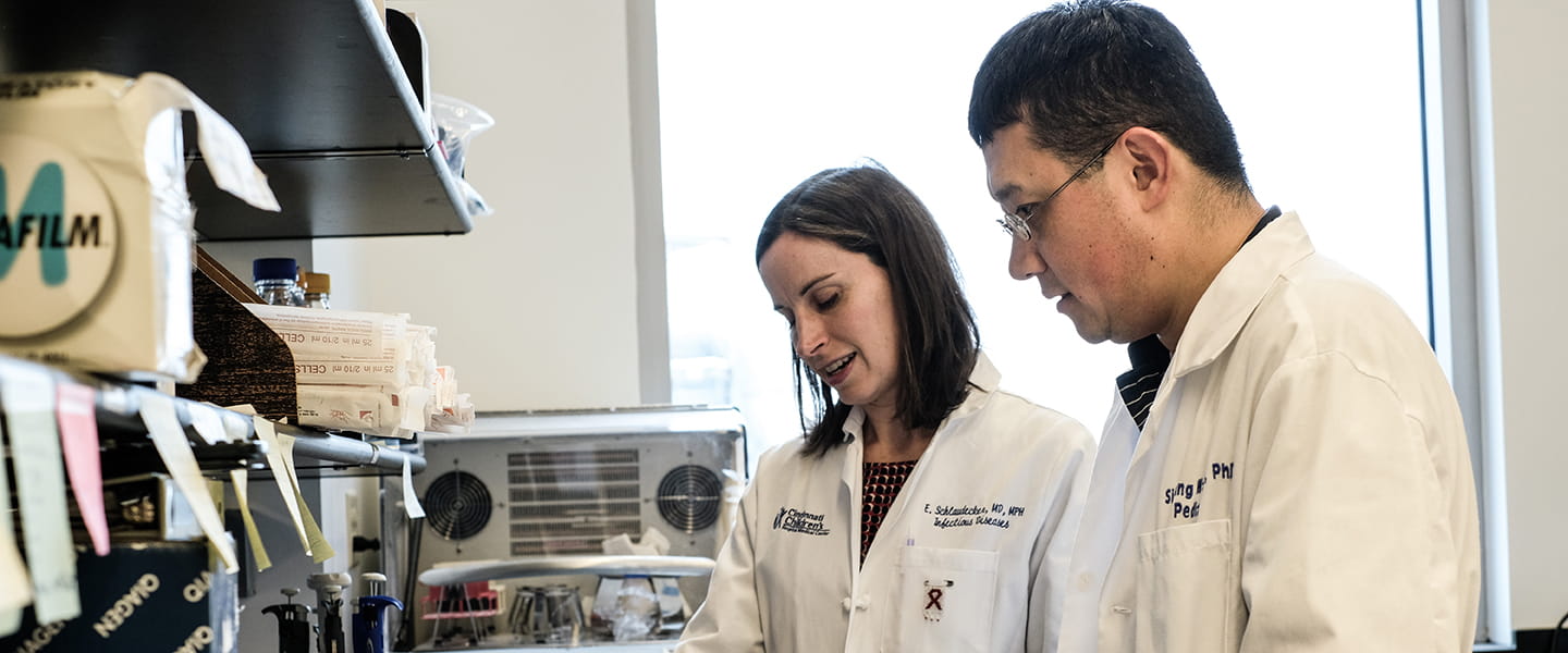A photo of two scientists working together in a lab.