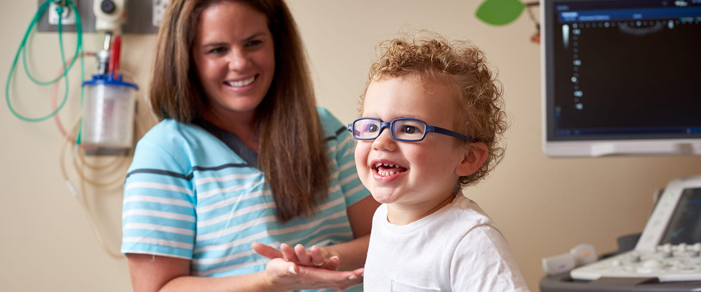 A photo of a patient and his mother in an exam room.