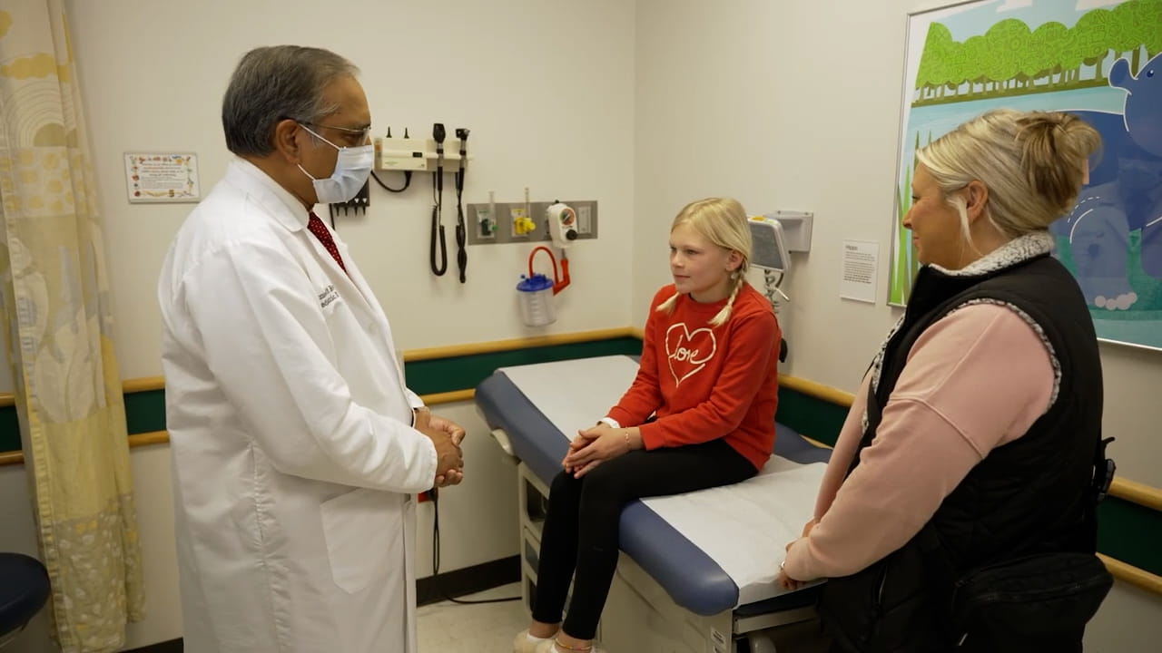 A patient and her mother speak with a provider.