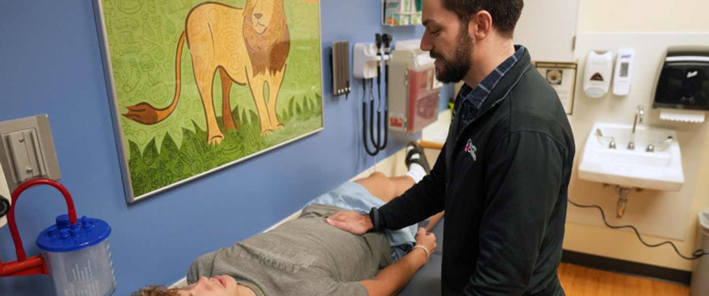 A physician examines a patient.