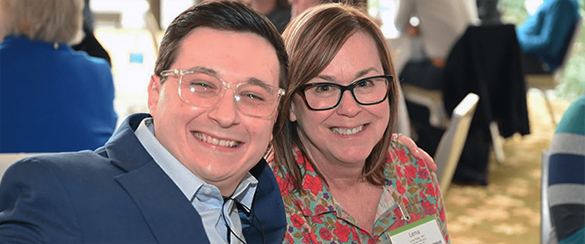 A man and woman smiling at the camera.