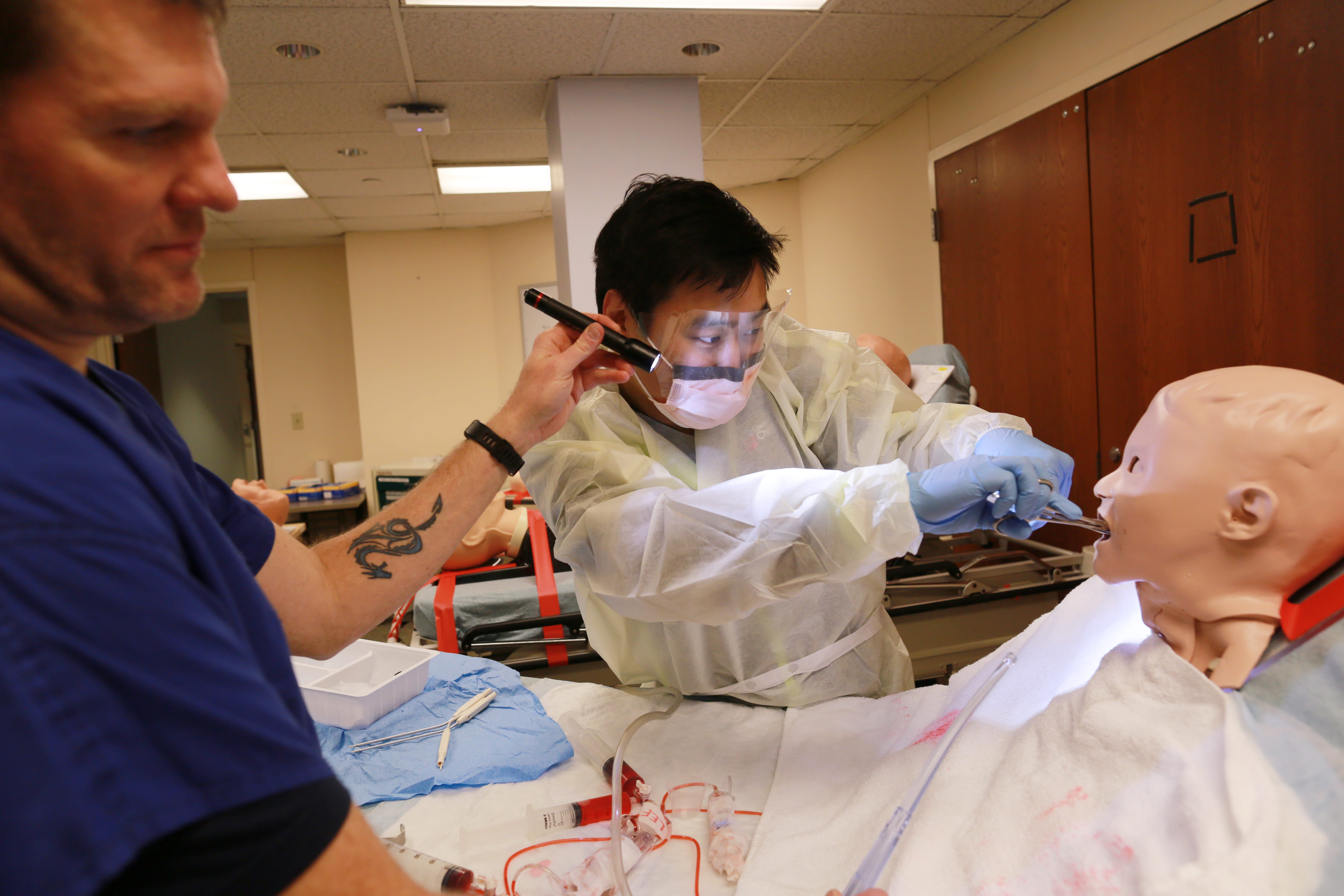 Practitioners working with a mannequin in the Simulation Center