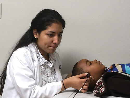Fig. B. Tracking the velocity of blood flow in the brain is a key measure of stroke risk for patients with sickle cell disease. Cincinnati Children’s has donated equipment and trained local medical teams to perform transcranial Doppler tests in three nations so far.
