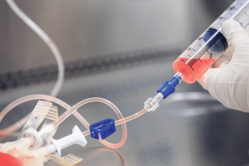 Team members in the Cell Manipulations Laboratory must wear sterile suits while they prepare gene-corrected stem cells for blood or bone marrow transplants.