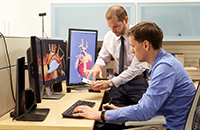 An image of two people working in the media lab facility.