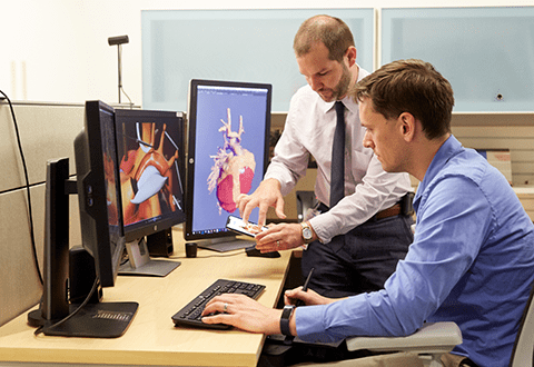 A photo of Media Lab Facility employees collaborating.