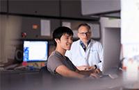 A photo of two researchers talking.