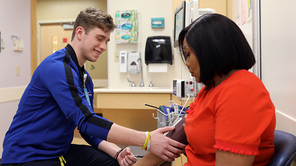 A provider checking a patient.