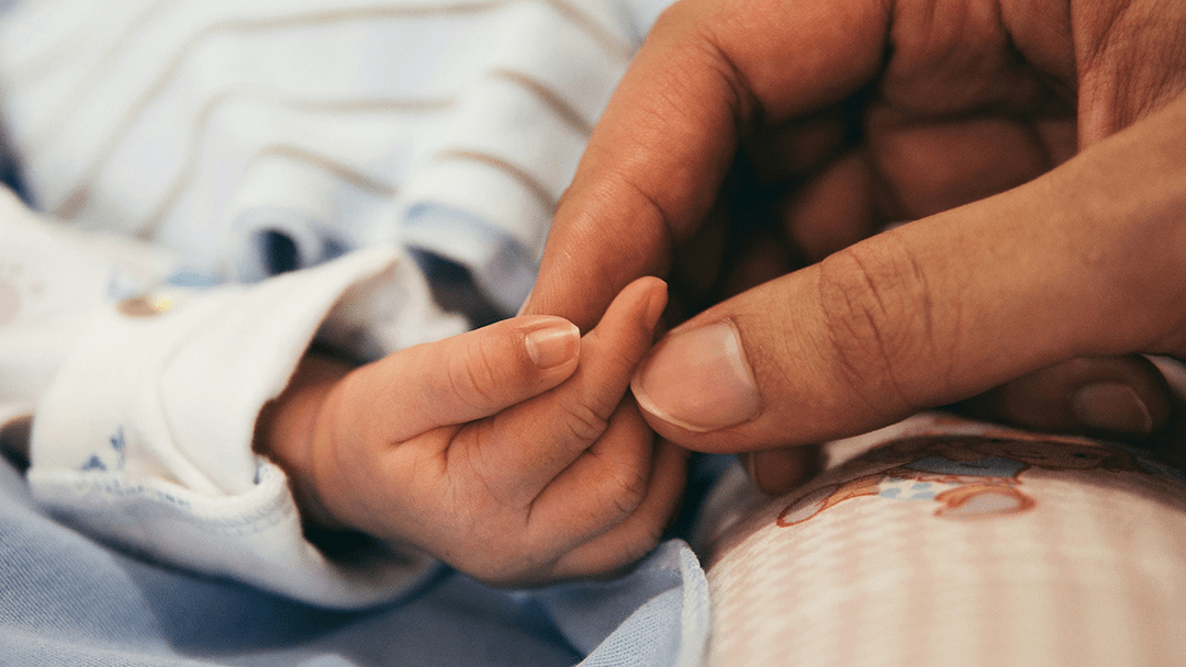 Researcher outside of an MRI looking at a computer.