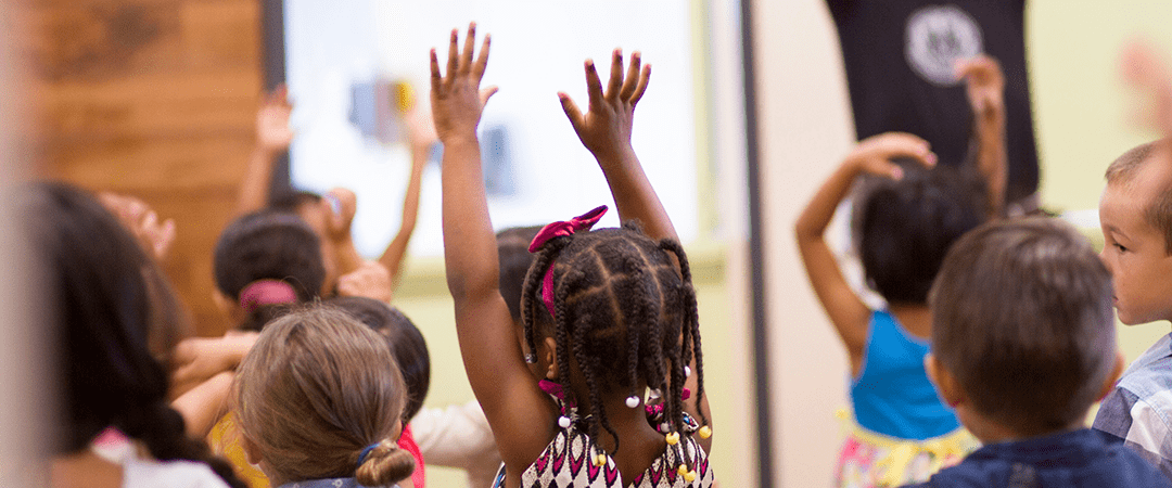 Four boys with their arms around each other.