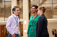 An image of three faculty members talking.