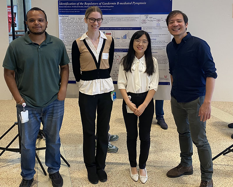 Dr. Panganiban and lab members presenting their work.