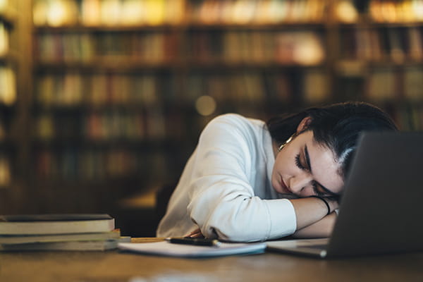 Teen asleep with laptop.