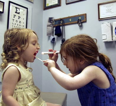 Two little girls playing doctor.