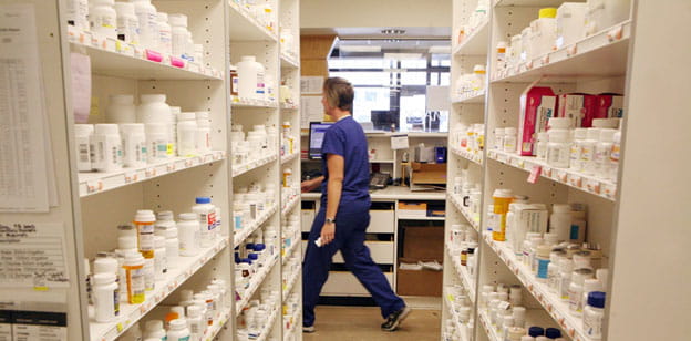 woman walking through pharmacy.