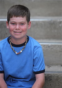 Child sitting on steps.