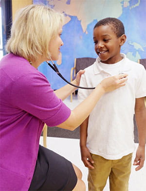 A nurse listens to sam's heart beat.