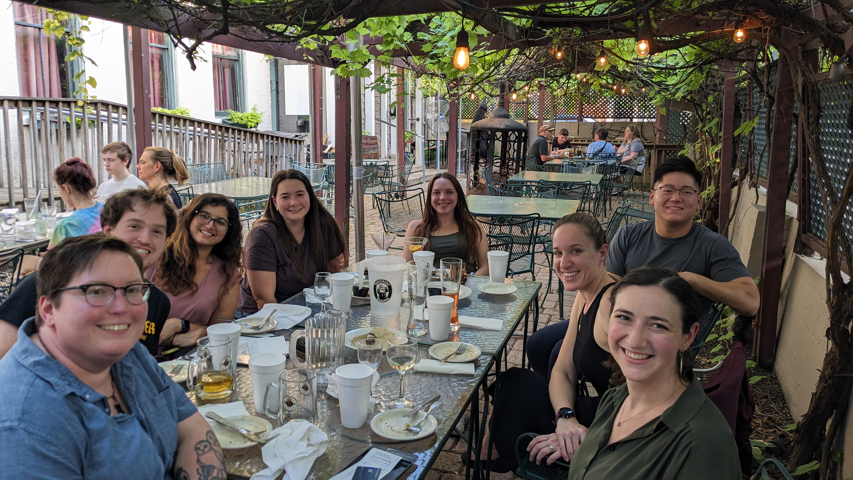 Group of lab members at a dining table.