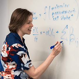 Emily Miraldi works at whiteboard.