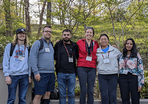 Lab members pose for a photo outside.