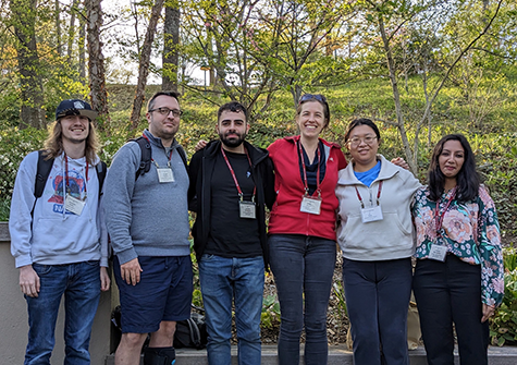 Lab members pose for a photo outside.