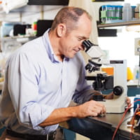 Dr. Molkentin looking in a microscope.