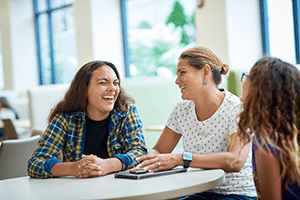 An image of three people laughing.