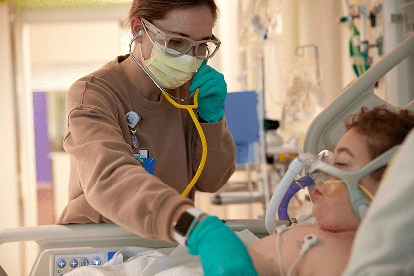 A sleeping patient with a nurse.