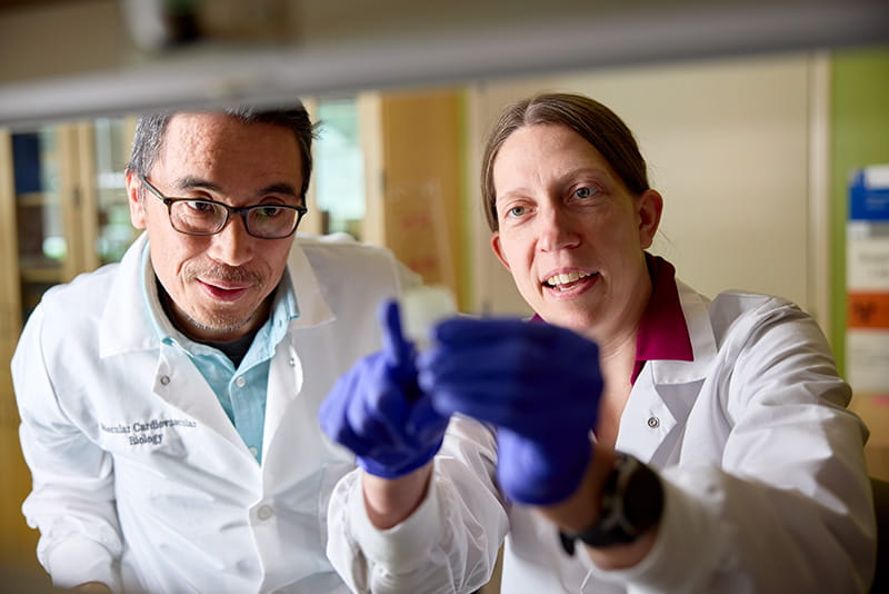Two clinicians look at a discovery.
