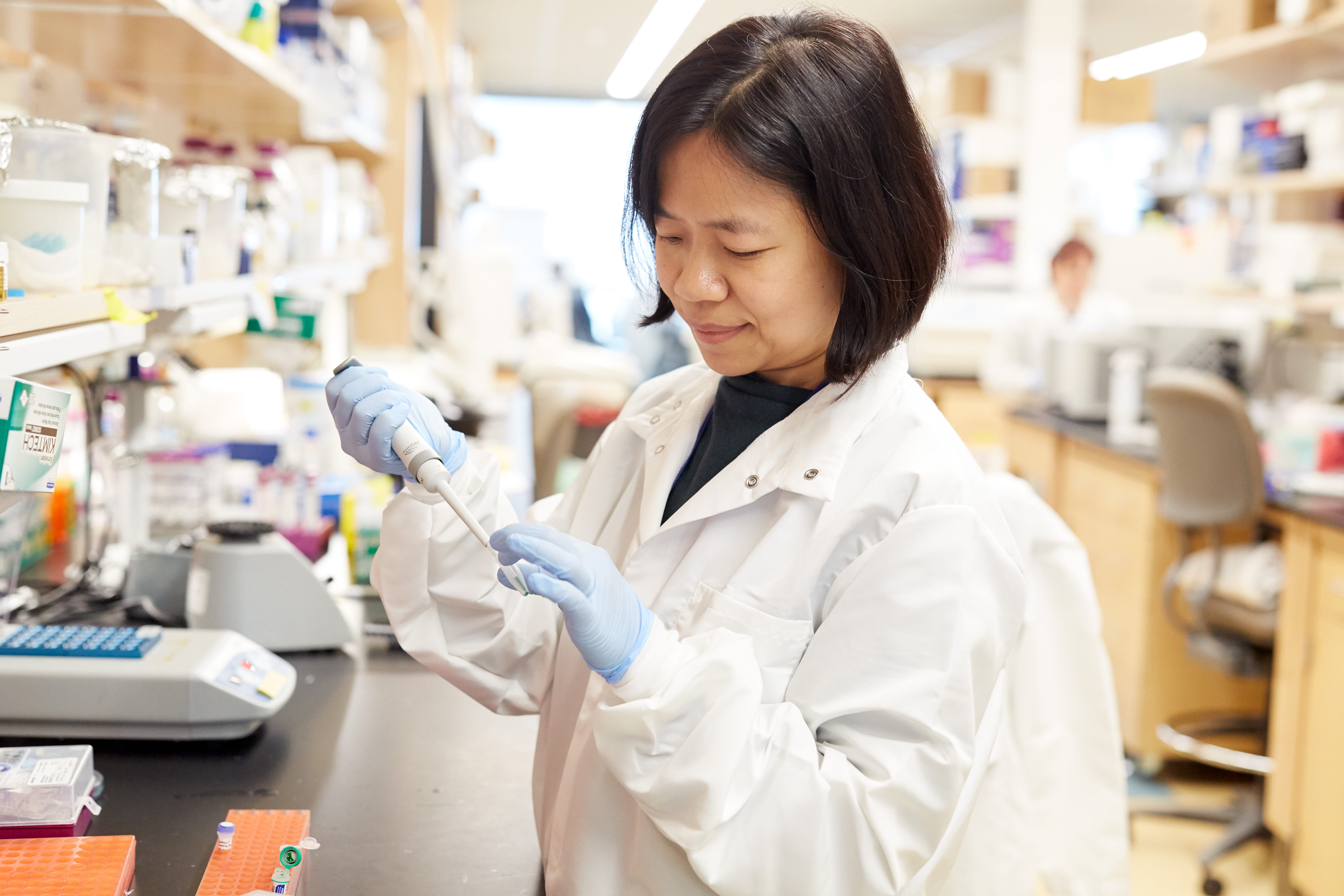 Scientist uses a pipette in her research