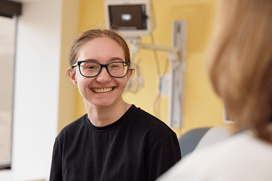 Katie smiles during a clinic visit.