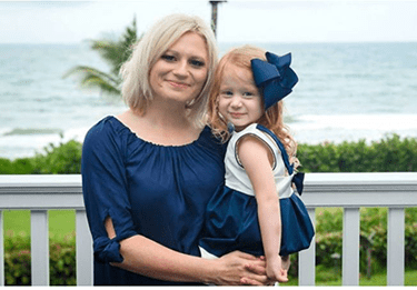 A photo of an ACHD patient holding her daughter.