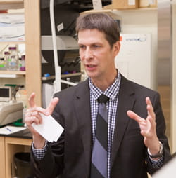 Alexander G. Miethke, MD, talks inside his lab. 