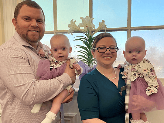 Cole and Lynae hold their twins.