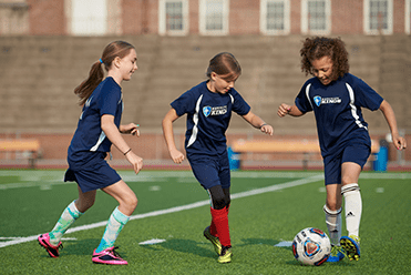 An image of girls playing soccer.
