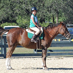 Ella on horseback.