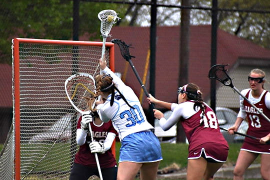 Erika competes in a lacrosse match.