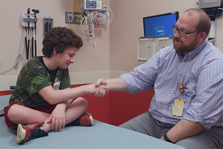 Kelly Murphy smiling at a 2 year check-in with his Neuro-oncologist.