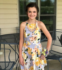 Lillian, 13, smiles.