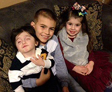 CHARGE patient Everett with his siblings.