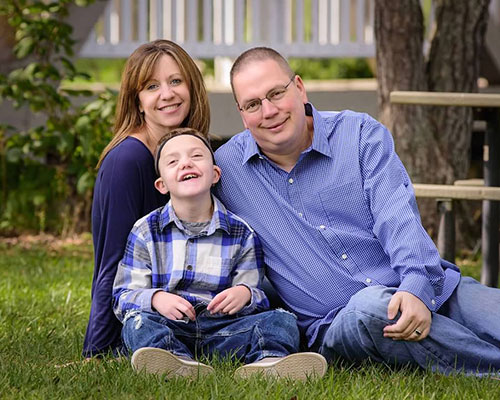 Logan with his mom and dad.