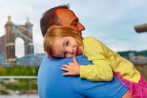Girl hugs dad.